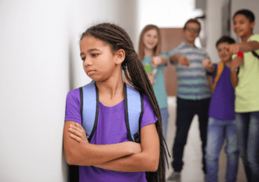 child at holiday club looking sad because of bullying