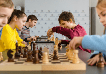 children at holiday club playing chess